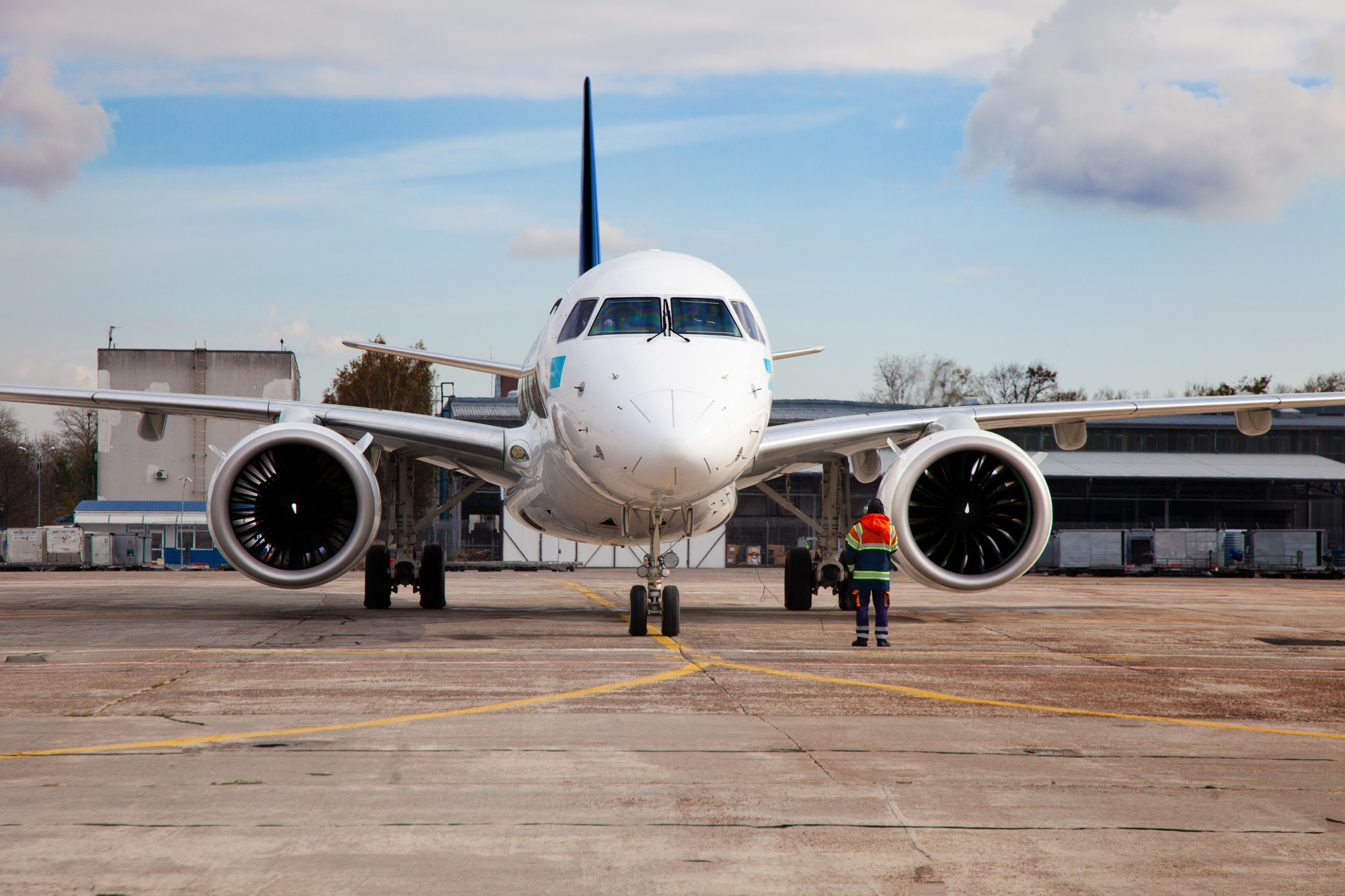 Passenger plane at the airport background. The plane lands at the international airport. White