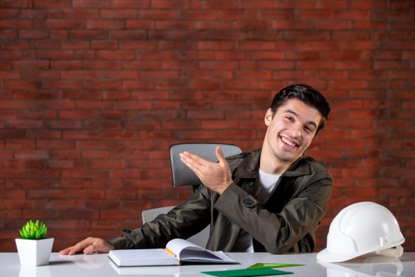 front-view-male-engineer-sitting-his-working-place-job-business-contractor-agenda-corporate-builder-property-plan-document